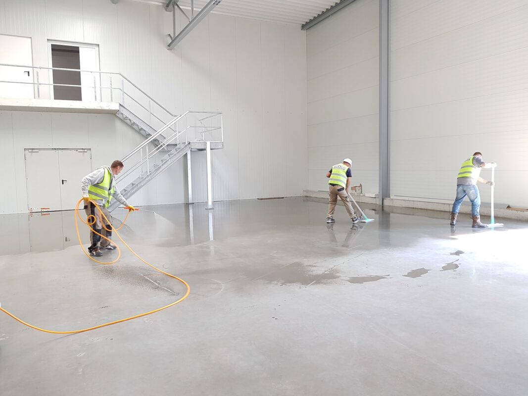 A team cleaning a factory floor